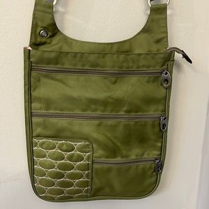 Crossbody bag green with pink detailing. Lots of pockets. Stainless hardware
